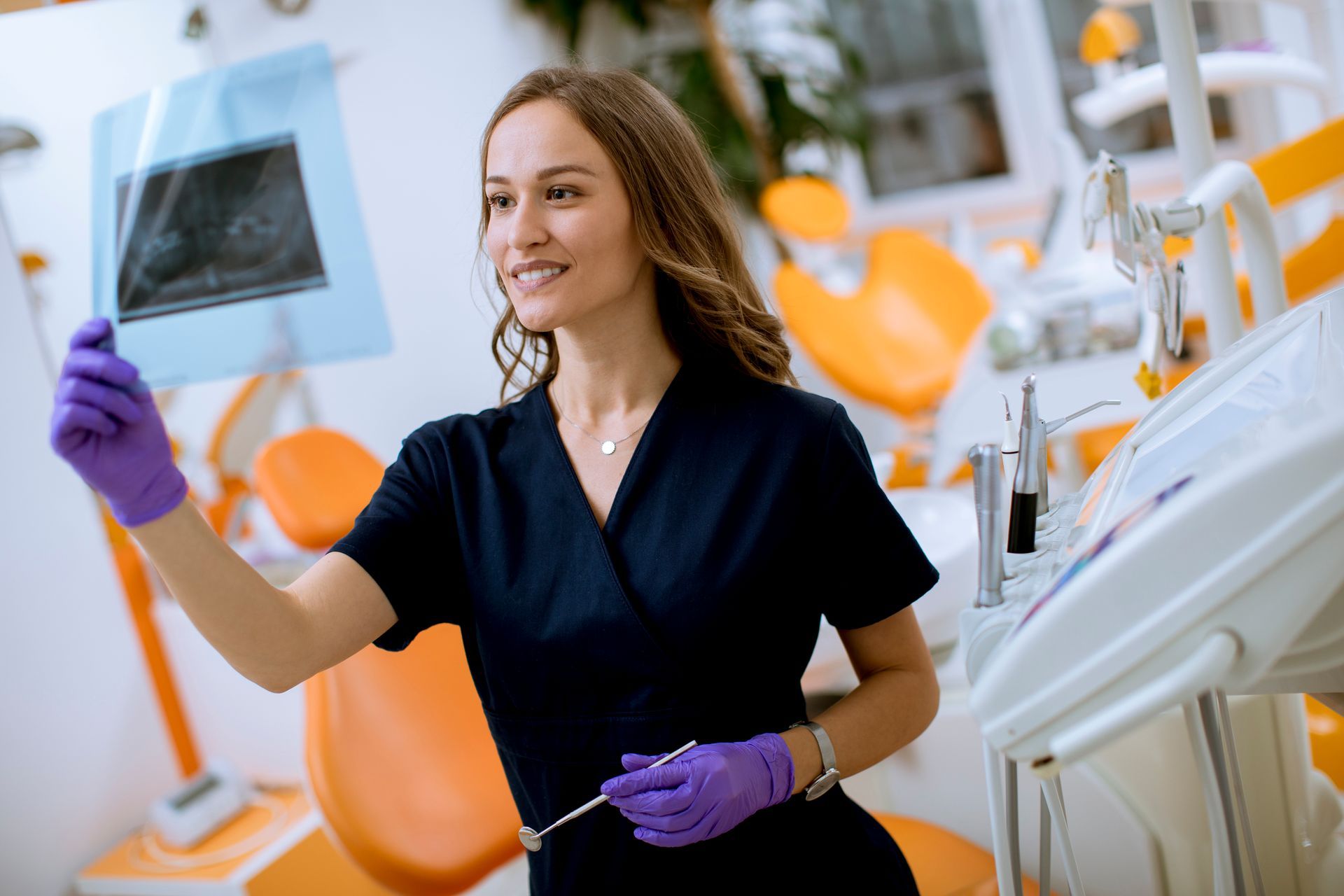 Dental professional reviewing an X-ray